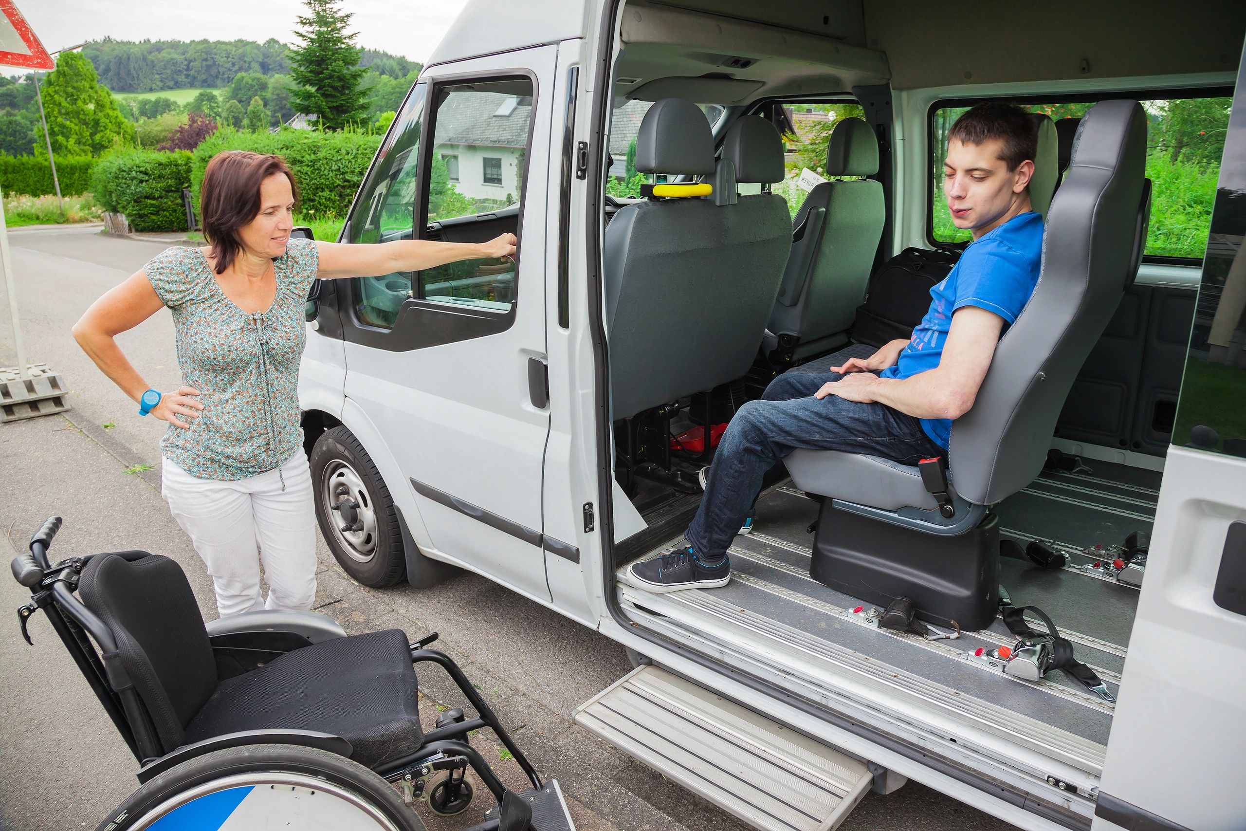 Man Sitting In Van While Woman Standing By